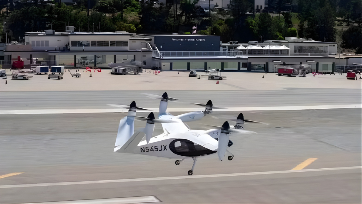 Electric aircraft lifting off near airport terminal during test flight
