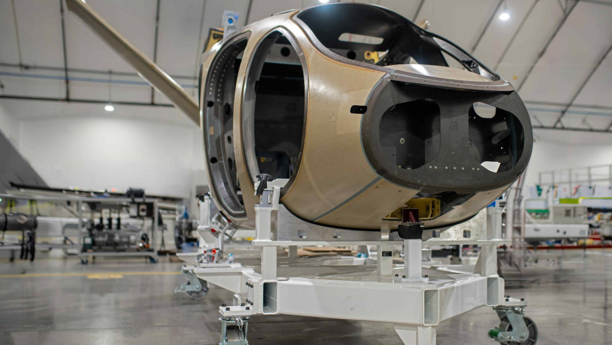 Electric air taxi fuselage undergoing assembly inside a manufacturing facility
